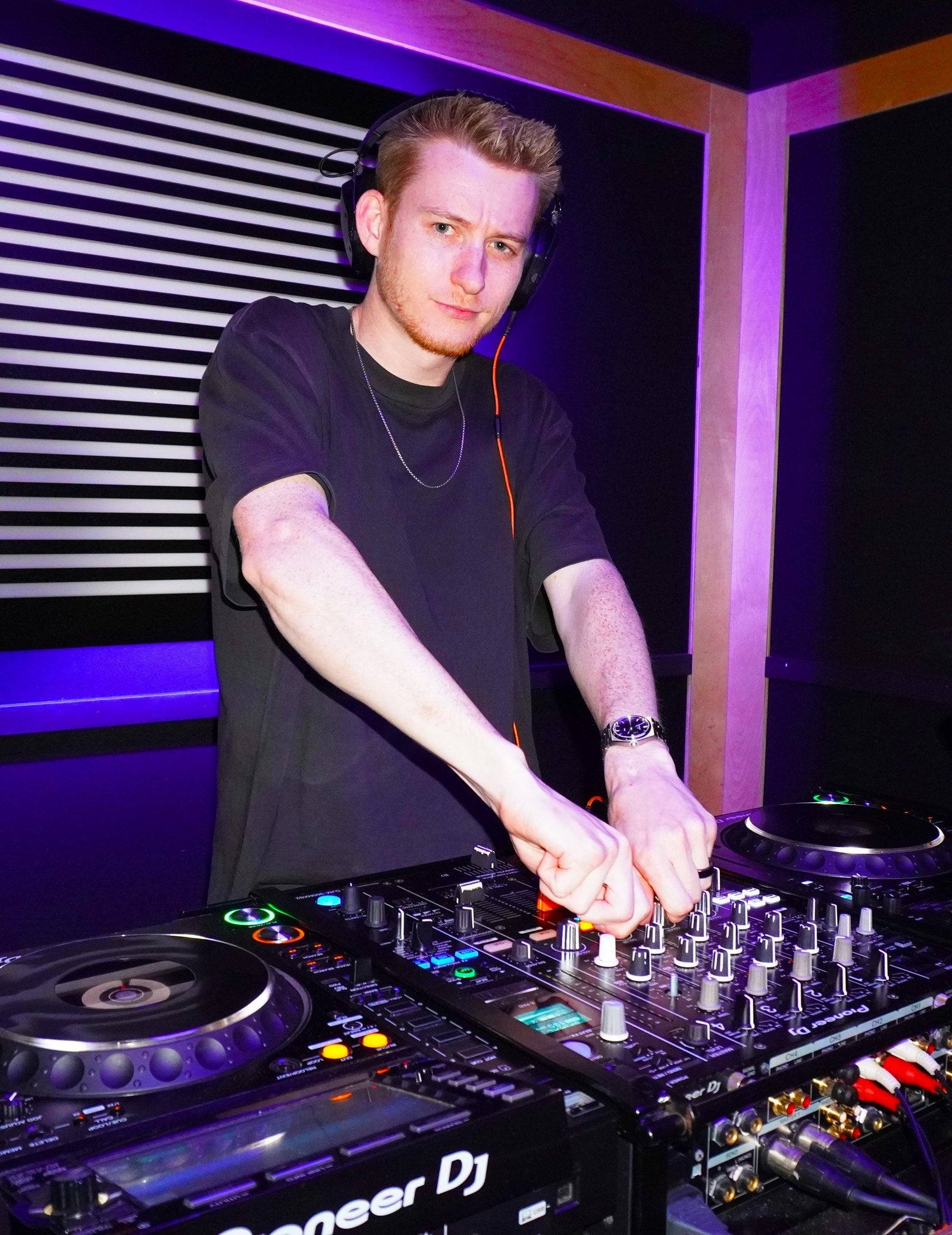Aglet adjusting the mixer while DJing